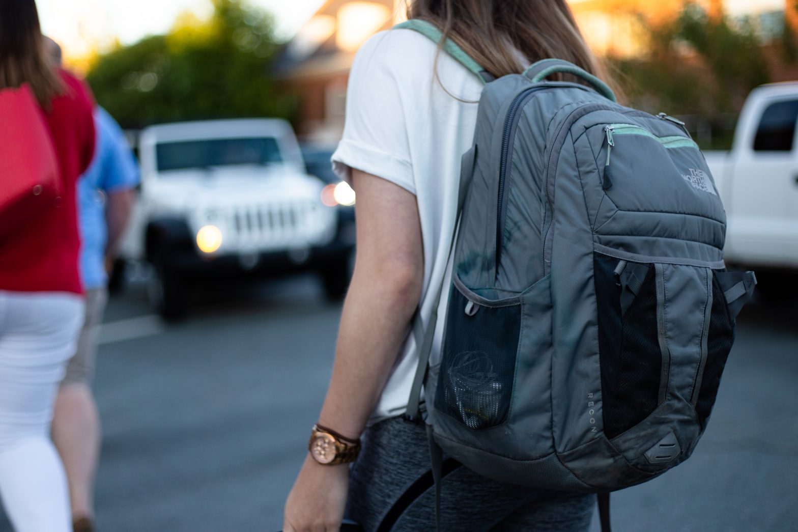 Woman holding backpack outside